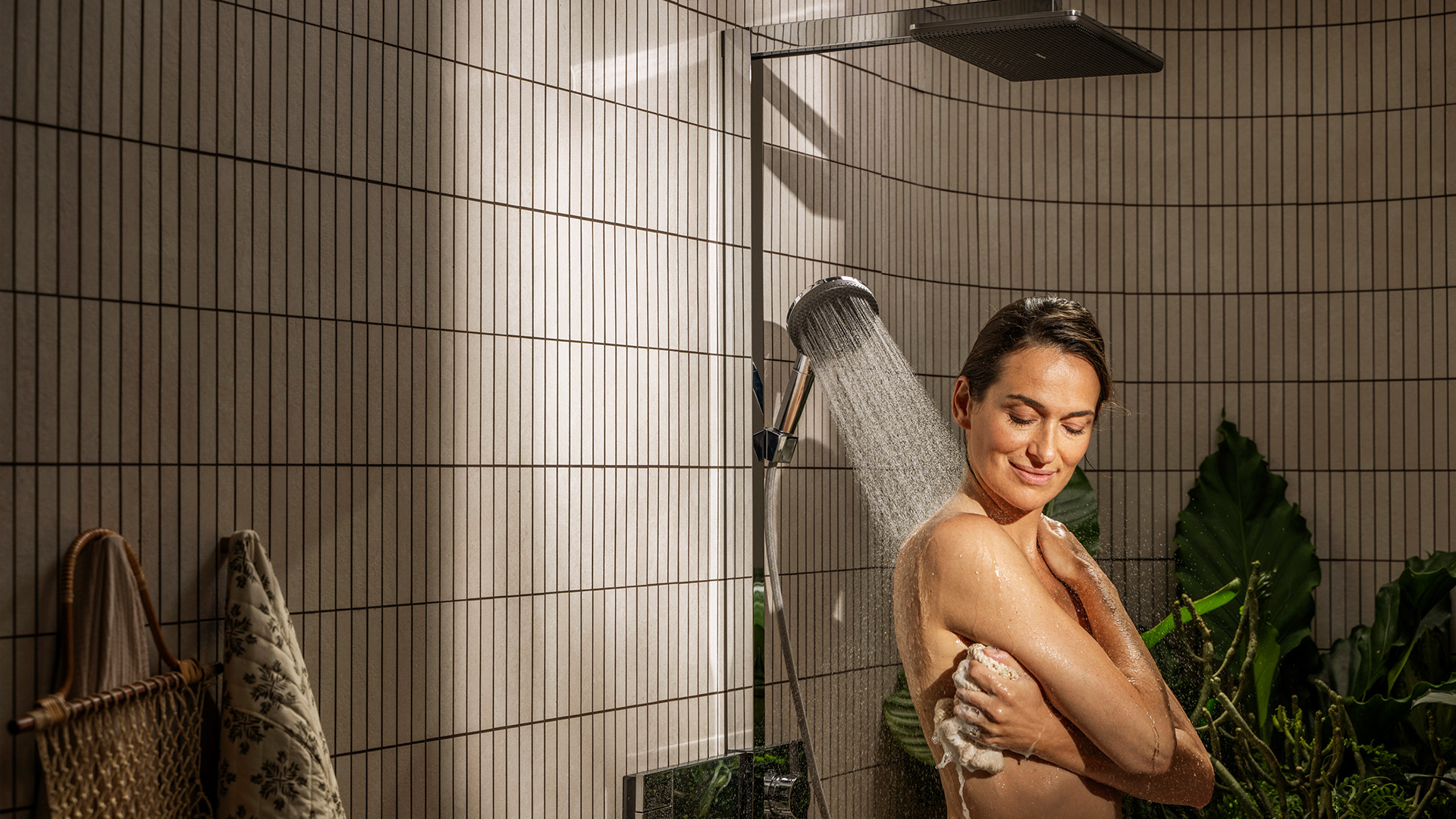 Woman showers under Raindance Alive.